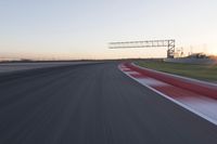 Dawn Automobile Racing on an Asphalt Road