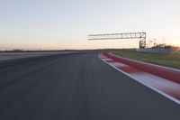 Dawn Automobile Racing on an Asphalt Road