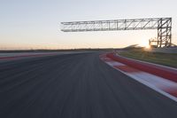 Dawn Automobile Racing on an Asphalt Road