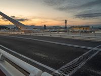 Dawn in Barcelona: Cityscape, Bridge, and Ocean