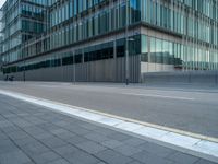 the road is empty on this busy street with the tall building in the background for pedestrians