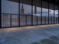 empty concrete floors in a large building by some large windows on a cloudy day or winter