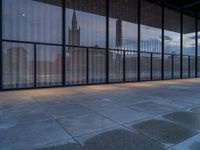 empty concrete floors in a large building by some large windows on a cloudy day or winter