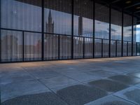 empty concrete floors in a large building by some large windows on a cloudy day or winter