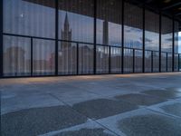 empty concrete floors in a large building by some large windows on a cloudy day or winter