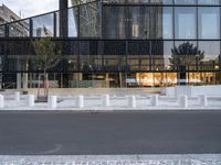 there are white pillars on the side of a building in the street by a fence