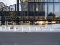 there are white pillars on the side of a building in the street by a fence