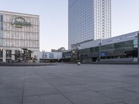 an empty, empty street in front of the large building near a pedestrian crosswalk