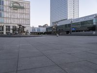 an empty, empty street in front of the large building near a pedestrian crosswalk