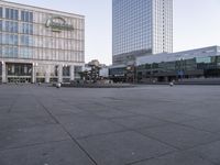 an empty, empty street in front of the large building near a pedestrian crosswalk