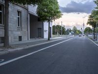 the empty street in front of a large building is empty and is not visible yet