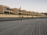 this is an empty boardwalk outside a building with windows and balconies on the sides