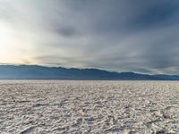 the barren land looks empty and very beautiful under a blue sky with some clouds above