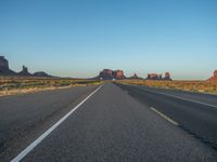 Dawn Breaking: Asphalt Road and Clear Sky