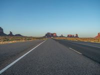 Dawn Breaking: Asphalt Road and Clear Sky