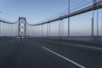 the view of the bridge from an approaching car on the road as seen from behind the windshield