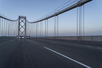 the view of the bridge from an approaching car on the road as seen from behind the windshield