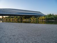 there are two very long bridges that are above the river shore at dusk here, and you can see how close them are