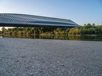 there are two very long bridges that are above the river shore at dusk here, and you can see how close them are