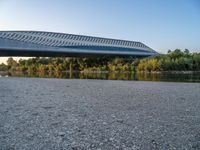 there are two very long bridges that are above the river shore at dusk here, and you can see how close them are