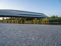 there are two very long bridges that are above the river shore at dusk here, and you can see how close them are