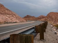 a highway along the side of a mountain with mountains in the background and no people at all