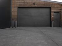 black garage doors outside an empty building on a cloudy day in a city area with no people