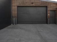 black garage doors outside an empty building on a cloudy day in a city area with no people