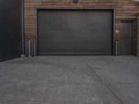 black garage doors outside an empty building on a cloudy day in a city area with no people