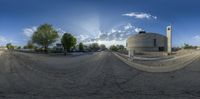 the view from a fish eye lens looking down at the street and buildings on either side of the road