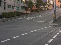 a street has a city bus passing by in front of it, and signs along the side of it