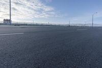 a empty road that is almost empty except for the people to walk around it and do not want to run into the distance