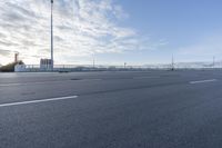 a empty road that is almost empty except for the people to walk around it and do not want to run into the distance