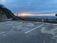 an empty parking lot with a view of a beautiful sunset over the city of san francisco