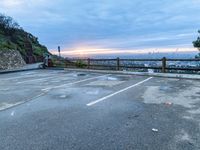 an empty parking lot with a view of a beautiful sunset over the city of san francisco