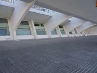 a view from outside on some buildings with windows and a sky line above them, and a person walking