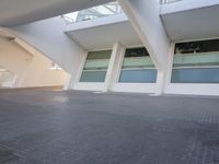 a view from outside on some buildings with windows and a sky line above them, and a person walking