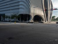 the car is at a traffic light as it approaches the building from the street level