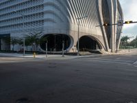 the car is at a traffic light as it approaches the building from the street level