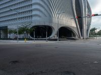 the car is at a traffic light as it approaches the building from the street level