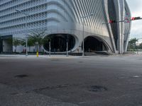 the car is at a traffic light as it approaches the building from the street level