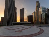 a city circle with skyscrapers in the background and a bench at the center of it