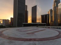 a city circle with skyscrapers in the background and a bench at the center of it