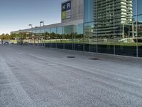 a view of an empty parking lot from another road with a reflection in the glass windows