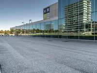 a view of an empty parking lot from another road with a reflection in the glass windows