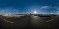 a long shot of a street with some traffic lights on it and another road next to the camera