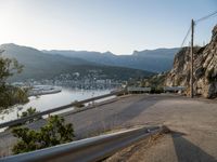 a very steep mountain side with a city on it next to the water and some mountains