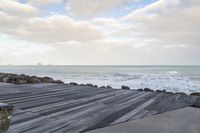 the boardwalk has a very nice looking surface near the ocean for the view, a lot of rocks in the water