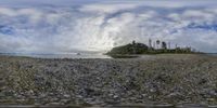 a panoramic view of a body of water and rocks next to the shore