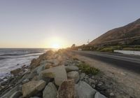 Dawn on a Coastal Road: Asphalt and Mountain Views